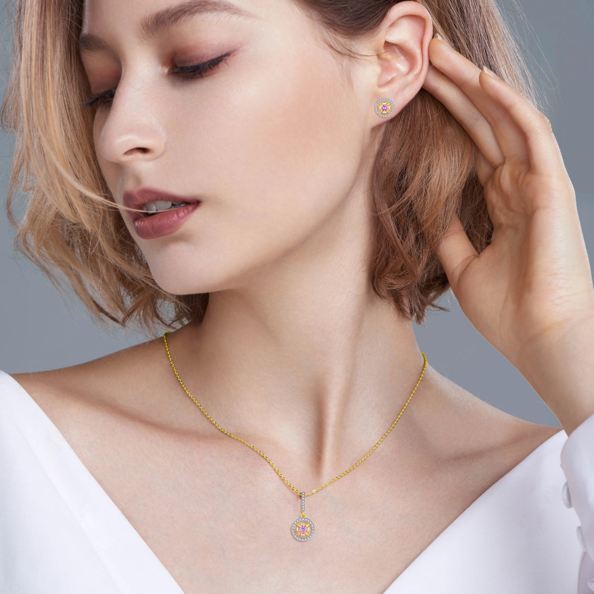 Model wearing Blush Halo moissanite necklace and matching stud earrings in gold-tone 925 sterling silver
