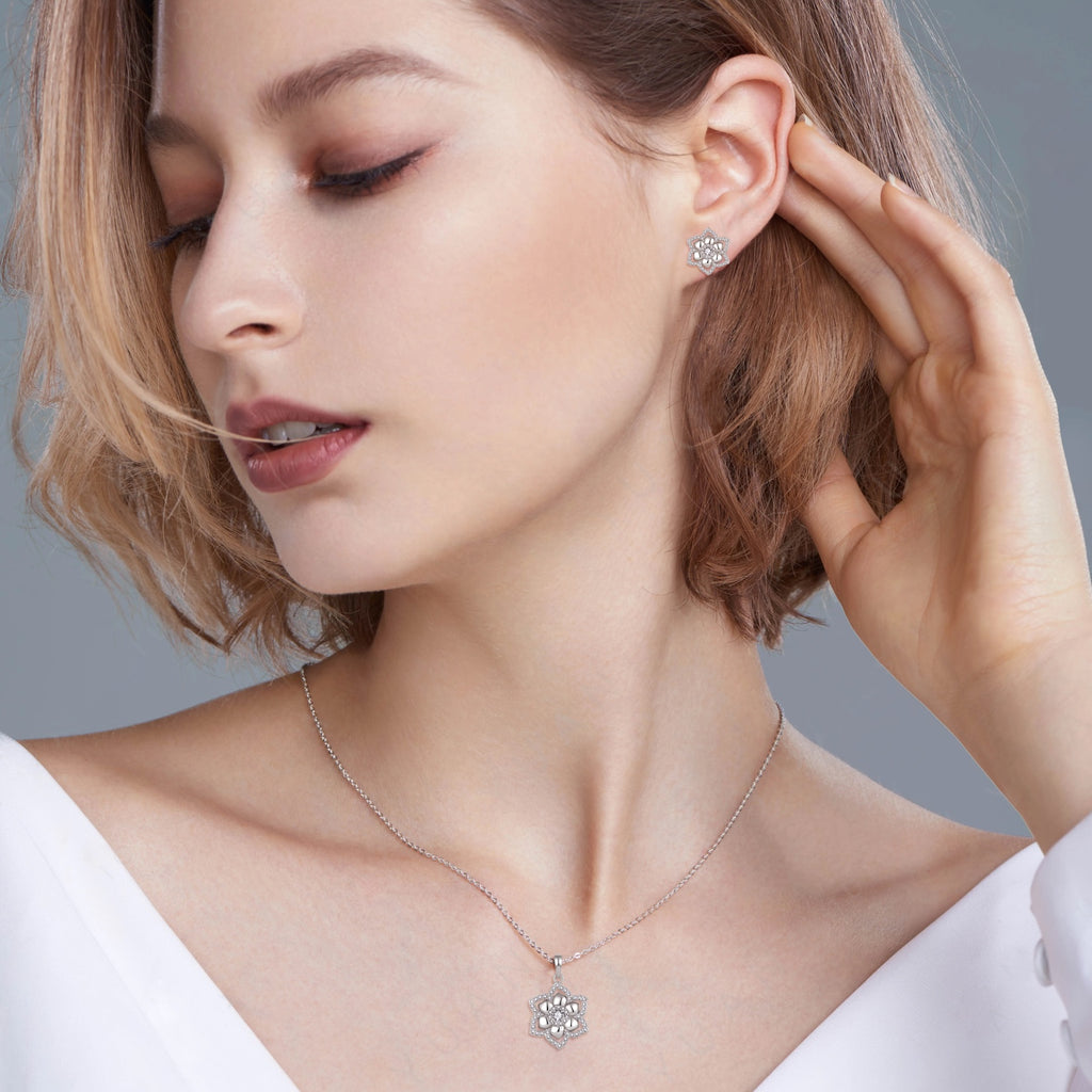 Model wearing Celeste Floral moissanite necklace and matching stud earrings in 925 sterling silver