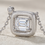 Close-up of Marhabu emerald-cut moissanite in frosted square S925 pendant