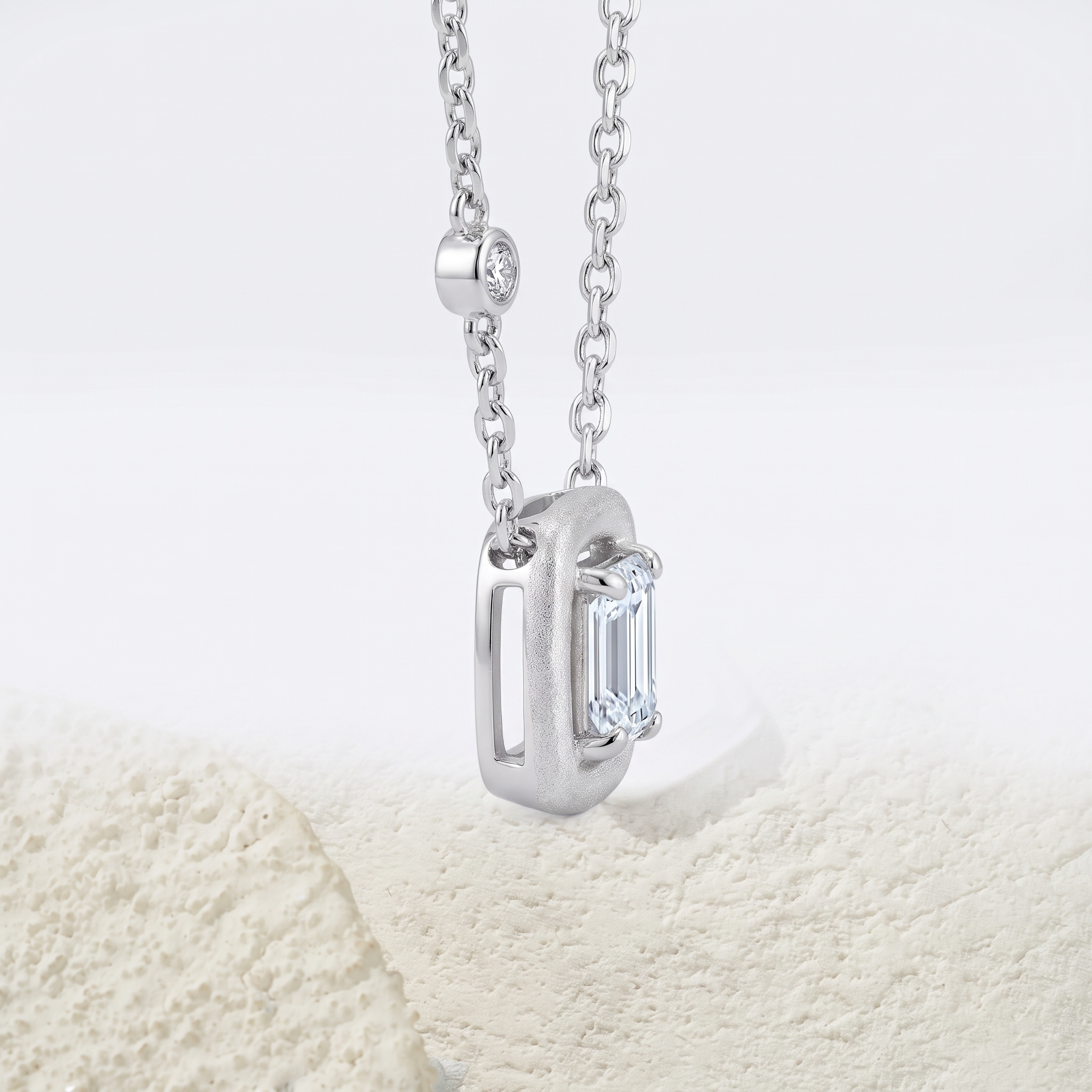 Side profile of Marhabu S925 emerald-cut moissanite square pendant necklace
