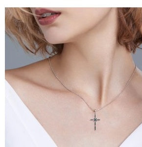 Model wearing Midnight Cross moissanite pendant necklace in 925 sterling silver
